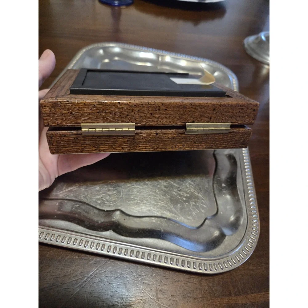 vintage bifold photo frame features a dark brown wood-grain finish and brass...